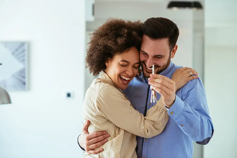Personal Insurance - Excited Couple Celebrating the Purchase of Their New Home